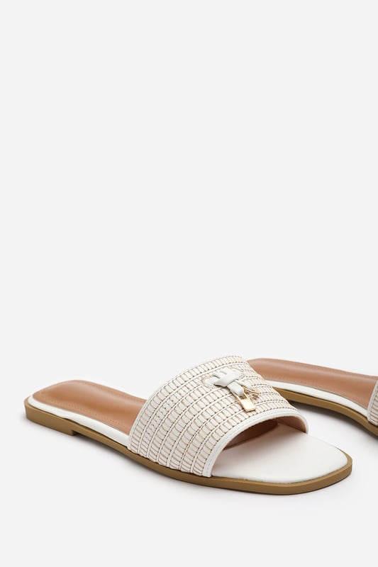 Introducing our Alaska strap sandal with front straw strap lock detail, the perfect combination of style and comfort. These sliders are an essential addition to your footwear collection, offering versatility and elegance for any occasion.
Key Features:

Lock Detail strap: The stunning lock detail strap on the front adds a touch of glamour and makes these sliders stand out from the crowd.


Chic Design: The faux leather material gives these sliders a sophisticated look that will elevate any outfit, whether you're dressing up for a special occasion or keeping it casual for daily use.
Comfortable Fit: We understand the importance of comfort, which is why these sliders are designed with a comfortable fit in mind. Slip them on effortlessly and enjoy a relaxed feel that lasts all day.
Durable Construction: Crafted with high-quality materials, these sliders are built to last. The breathable and odor-resistant foam ensures a comfortable and fresh wearing experience.
Perfect for Any Occasion:&nbsp;Whether you're headed to the beach, a casual outing, or a night out with friends, these versatile sliders are suitable for any occasion, adding a touch of elegance to your look.

Specifications:

Material: Faux Leather
Closure: Slip-on
Sole: Rubber sole for comfort and traction

Invest in our Alaska strap sandal with front straw strap lock detail and experience the perfect blend of style, comfort, and durability. Step out with confidence and make a fashion statement with every stride.