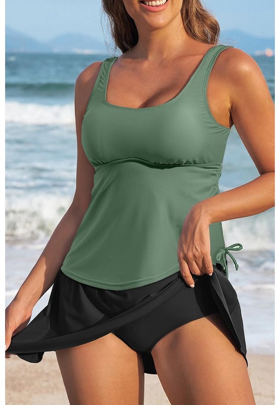 Our styles are designed with a trendy fitted look in mind following an international size standard. For the best fit we suggest choosing one size up from your usual. Be sure to check our sizing chart to find your perfect match!
  Mist Green Scoop Neck Adjustable Tankini and Matching Skort Bathing Suit
  2
  piece set: tankini top and skort bottom
  Padded cups for added support
  Adjustable straps for a customized fit
  Drawstring at the side for adjustable coverage
  Matching skort bottom with attached panties
  Available in solid color sets or mix
  and
  match styles
  High elasticity for a comfortable fit
Material: 82% Polyamide 18% Elastane