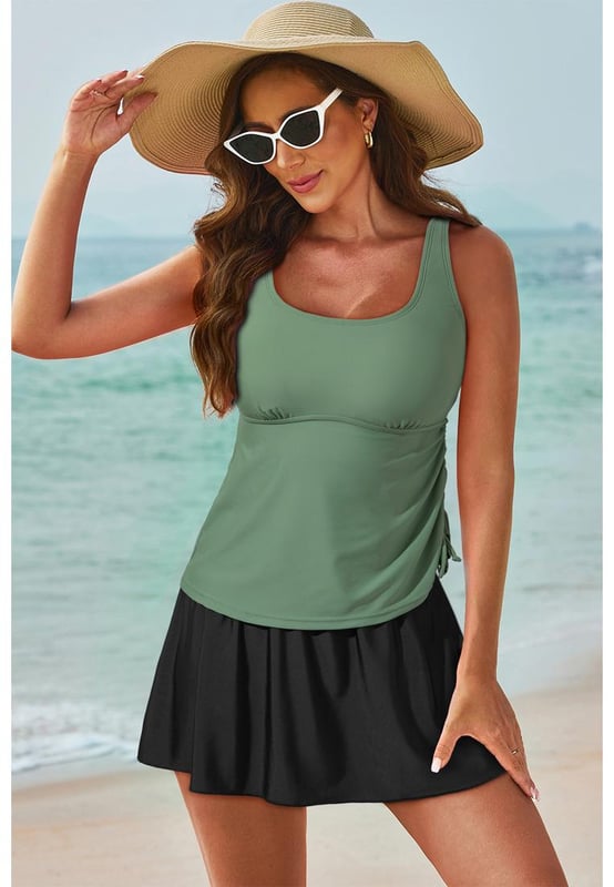 Our styles are designed with a trendy fitted look in mind following an international size standard. For the best fit we suggest choosing one size up from your usual. Be sure to check our sizing chart to find your perfect match!
  Mist Green Scoop Neck Adjustable Tankini and Matching Skort Bathing Suit
  2
  piece set: tankini top and skort bottom
  Padded cups for added support
  Adjustable straps for a customized fit
  Drawstring at the side for adjustable coverage
  Matching skort bottom with attached panties
  Available in solid color sets or mix
  and
  match styles
  High elasticity for a comfortable fit
Material: 82% Polyamide 18% Elastane