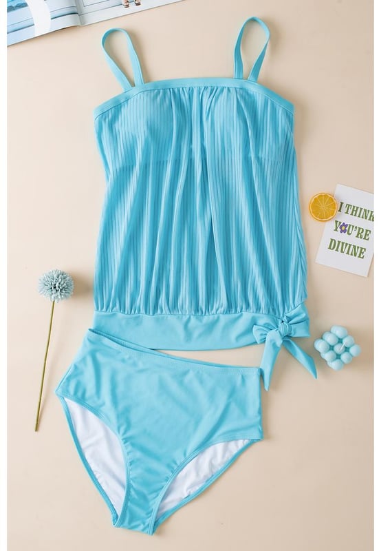 Our styles are designed with a trendy fitted look in mind following an international size standard. For the best fit we suggest choosing one size up from your usual. Be sure to check our sizing chart to find your perfect match!
  Flattering and stylish tankini
  Turquoise striped mesh design
  Trendy knotted hem detail on the top
  High
  rise design for easy pull
  on
  Adjustable straps for a customizable fit
  Removable padded cups for added support and coverage
  Versatile tankini suitable for pairing with coverups
Material: 82% Polyamide 18% Elastane