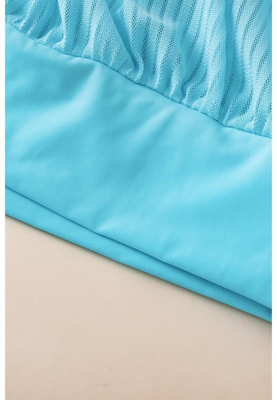 Our styles are designed with a trendy fitted look in mind following an international size standard. For the best fit we suggest choosing one size up from your usual. Be sure to check our sizing chart to find your perfect match!
  Flattering and stylish tankini
  Turquoise striped mesh design
  Trendy knotted hem detail on the top
  High
  rise design for easy pull
  on
  Adjustable straps for a customizable fit
  Removable padded cups for added support and coverage
  Versatile tankini suitable for pairing with coverups
Material: 82% Polyamide 18% Elastane