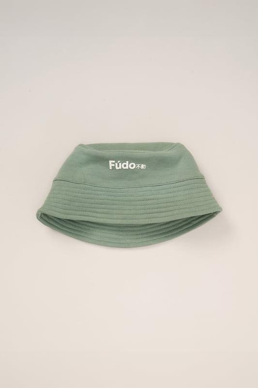 This stylish 3-Piece outfit set from Fudo includes a short-sleeve t-shirt, shorts, and a matching bucket hat. The t-shirt and hat feature a bold Fudo logo on the front, while the back of the tee showcases a large graphic palm tree print for a statement look. The shorts are designed with mesh panel details and two side pockets, perfect for laid-back, everyday style.