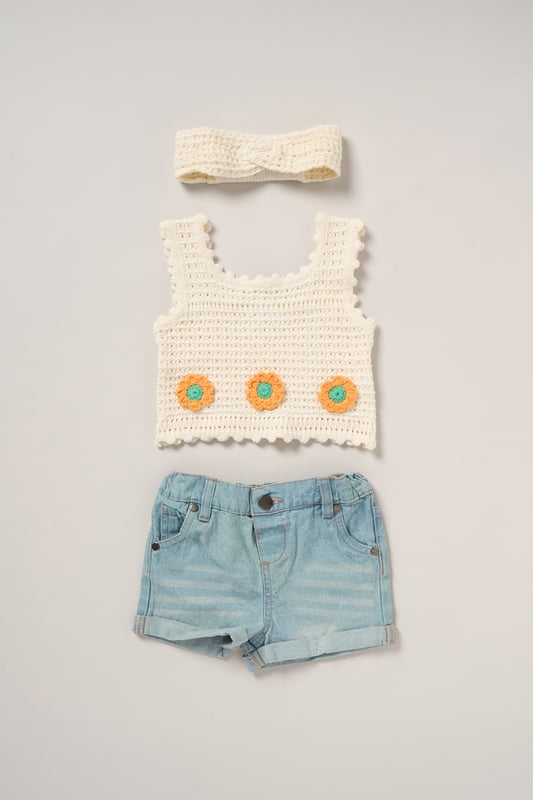 This adorable set by Miss includes a true knit top, denim shorts, and a matching headband. Perfect for warm days, it combines style and practicality, making it an ideal choice for playdates, outings, or casual summer looks.