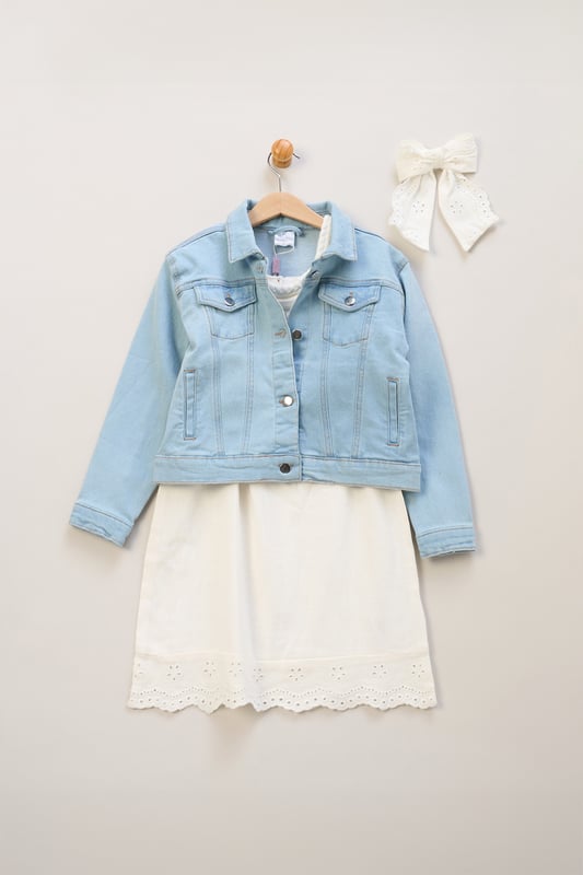 This floaty broderie dress by Miss, featuring delicate crochet panel detailing, is a versatile wardrobe must-have. Paired with a matching bow hair clip and finished with a classic denim jacket, it's perfect for breezy days and stylish outings.