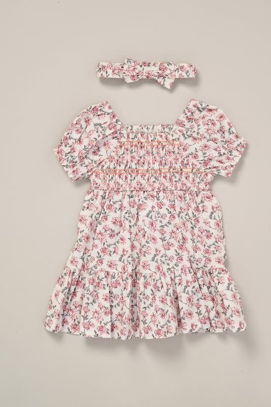 This printed summer dress and bow headband outfit set by Miss is the perfect addition to your little one’s summer wardrobe. The dress features tiered ruffles, cap sleeves, and a delicate floral print, creating a cute look perfect for sunny days, casual outings, or special occasions.