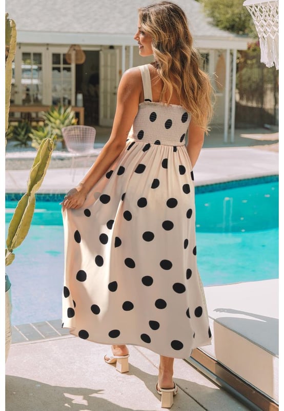 Elegant polka dot pattern
  Flattering silhouette with smocked bodice
  High waist design
  Flowy skirt for added grace
  Sleeveless for a flirty touch
  Ideal for pairing with layering necklaces and high heels
Material: 100% Polyester
