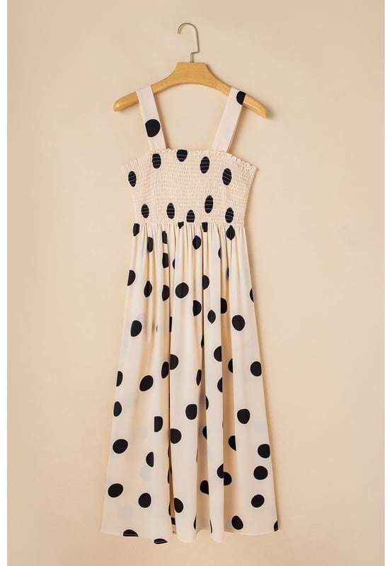 Elegant polka dot pattern
  Flattering silhouette with smocked bodice
  High waist design
  Flowy skirt for added grace
  Sleeveless for a flirty touch
  Ideal for pairing with layering necklaces and high heels
Material: 100% Polyester