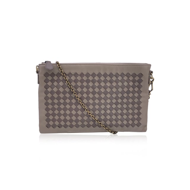 VINTAGE, RRP AS NEW
Elegant in its simplicity and rich in texture, this Bottega Veneta taupe leather zip pouch bag is a refined expression of the house's iconic craftsmanship. The front features Bottega's signature Intrecciato woven leather, a tactile nod to artisanal tradition, contrasted beautifully by the smooth leather body.  The bag opens with a sleek upper zipper closure, revealing a plush brown suede interior thoughtfully designed with six open side pockets and one larger slip pocket-perfectly organized for essentials. A removable gold-tone chain strap adds a touch of versatility and understated glamour.  Inside, the 'Bottega Veneta - Made in Italy' engraving stands as a quiet testament to its heritage-proof that timeless design never shouts, it whispers. Condition Rating: A - EXCELLENTCondition Details: Some light scratches on leather due to normal use. Please check the photos carefully and ask if you need to know more details or if you have any doubts.Measurements (cm):Depth: 2.5Height: 15.2Length: 24.1Other Details: Dustbag? YesKeys? NoBox? No Measurments:  width: 25 mm length: 241 mm height: 152 mm