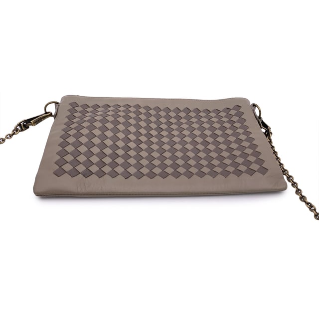 VINTAGE, RRP AS NEW
Elegant in its simplicity and rich in texture, this Bottega Veneta taupe leather zip pouch bag is a refined expression of the house's iconic craftsmanship. The front features Bottega's signature Intrecciato woven leather, a tactile nod to artisanal tradition, contrasted beautifully by the smooth leather body.  The bag opens with a sleek upper zipper closure, revealing a plush brown suede interior thoughtfully designed with six open side pockets and one larger slip pocket-perfectly organized for essentials. A removable gold-tone chain strap adds a touch of versatility and understated glamour.  Inside, the 'Bottega Veneta - Made in Italy' engraving stands as a quiet testament to its heritage-proof that timeless design never shouts, it whispers. Condition Rating: A - EXCELLENTCondition Details: Some light scratches on leather due to normal use. Please check the photos carefully and ask if you need to know more details or if you have any doubts.Measurements (cm):Depth: 2.5Height: 15.2Length: 24.1Other Details: Dustbag? YesKeys? NoBox? No Measurments:  width: 25 mm length: 241 mm height: 152 mm