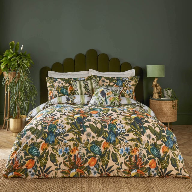 furn. Leilani Printed Floral Duvet Sets Transform your bedroom into an exotic sanctuary with the Leilani Duvet Cover Set. Crafted from a cotton blend fabric with a 180 thread count, this set offers both comfort and style. Each piece showcases a vibrant tapestry of tropical flora, fauna, and fruit, immersing you in a lush rainforest ambiance. Marvel at the songbirds amidst blooming foliage, where warm tones of blush and coral interplay with energetic teals and vivid oranges. Perfect for those who appreciate bold yet elegant decor, this set promises to express your unique personality and impress your guests.