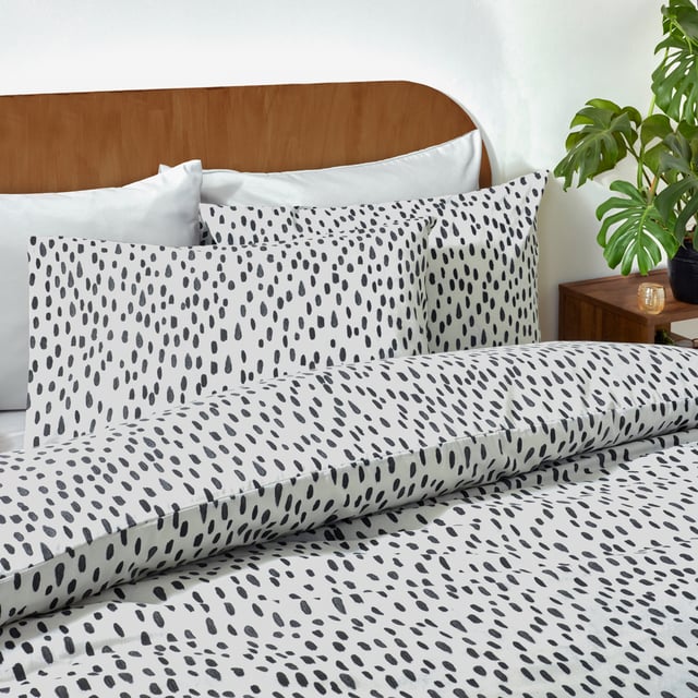 Transform your bedroom into a sanctuary of style and comfort with the Dottie Printed Duvet Cover Set. Crafted from a fabric blend with a 144 thread count, this set offers the perfect balance of softness and durability, ensuring restful nights every time. The playfully dotted design introduces a modern charm to your space, blending style with a hint of personality. Its lightweight, easy-care fabric simplifies your routine, allowing more time to enjoy your refreshed surroundings. Perfect for those who value both practicality and sophistication, this duvet cover set makes any bedroom feel effortlessly chic and uniquely yours.