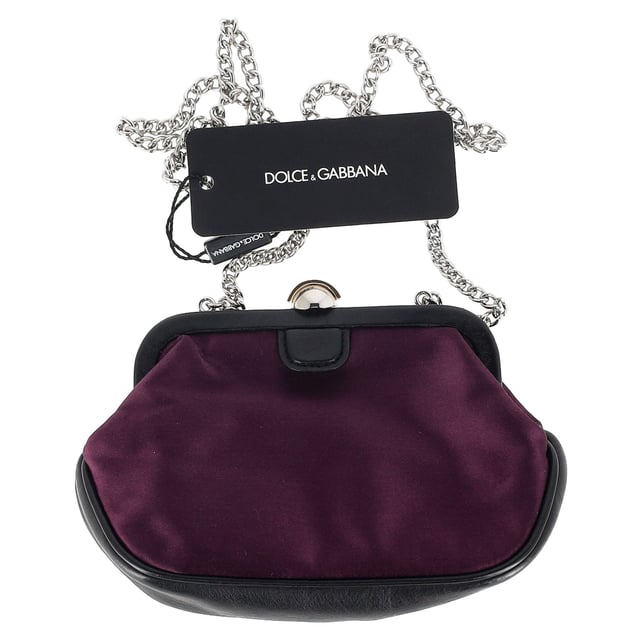 The Dolce & Gabbana Clasp Chain Clutch Bag in dark purple silk combines timeless elegance with bold luxury, featuring a lustrous silk fabric and ornate clasp closure. The rich purple hue adds a regal touch, making it the perfect accessory for evening events or formal occasions. Pair it with a little black dress or a sleek satin gown for a sophisticated, high-fashion look, or contrast it with a more casual outfit to elevate your style. The delicate chain strap allows for versatile wear, whether carried as a clutch or draped elegantly over the shoulder.

 Dolce & Gabbana Clasp Chain Clutch Bag in Dark Purple Silk

Condition: New with tag
Signs of wear: Out of store condition, no visible signs of wear.
Packaging: Dust bag
Color: Purple
Material: Silk
Size: One Size | One Size
Measurements: Width: 50; Height: 120; Length: 200
SKU: NAPPUGBBA464732W