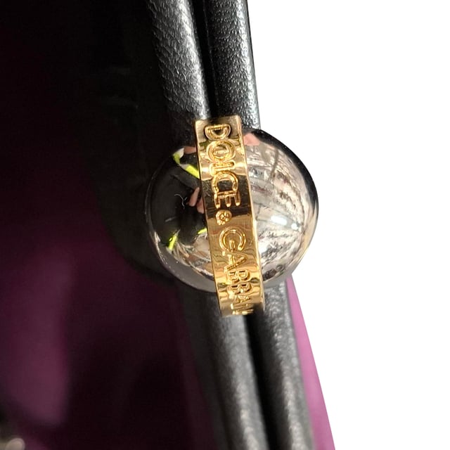 The Dolce & Gabbana Clasp Chain Clutch Bag in dark purple silk combines timeless elegance with bold luxury, featuring a lustrous silk fabric and ornate clasp closure. The rich purple hue adds a regal touch, making it the perfect accessory for evening events or formal occasions. Pair it with a little black dress or a sleek satin gown for a sophisticated, high-fashion look, or contrast it with a more casual outfit to elevate your style. The delicate chain strap allows for versatile wear, whether carried as a clutch or draped elegantly over the shoulder.

 Dolce & Gabbana Clasp Chain Clutch Bag in Dark Purple Silk

Condition: New with tag
Signs of wear: Out of store condition, no visible signs of wear.
Packaging: Dust bag
Color: Purple
Material: Silk
Size: One Size | One Size
Measurements: Width: 50; Height: 120; Length: 200
SKU: NAPPUGBBA464732W