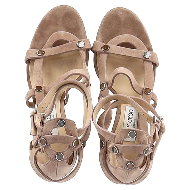 VINTAGE, RRP AS NEW
The Jimmy Choo Motoko 100 Sandal Heels in nude suede are a stunning fusion of elegance and edge. Featuring a sleek caged design with stone-effect studs, they wrap the foot in a flattering silhouette that elongates the legs. Set on a 100mm stiletto heel, they’re expertly crafted in Italy for a luxurious feel and flawless finish. **Styling tip:** Wear them with a slip dress or wide-leg trousers to balance the structured design with fluid movement and subtle sophistication.

 Jimmy Choo Motoko 100 Sandal Heels in Nude Suede

Condition: Good
Signs of wear: Moderate signs of wear
Packaging: None
Color: Brown | nude
Material: Suede
Size: IT | 40
Measurements: Heel height: 100; Insole length: 280
SKU: NAPPUGBSH472285W