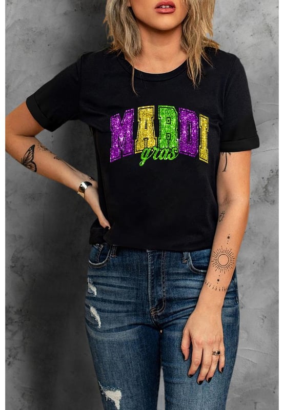 Our styles are designed with a trendy fitted look in mind following an international size standard. For the best fit we suggest choosing one size up from your usual. Be sure to check our sizing chart to find your perfect match!
  Black Mardi Gras Heat Transfer Graphic Holiday Tee
  Ideal for celebrating the carnival season
  Features iconic Mardi Gras elements
  Glittering heat
  transfer pattern adds a touch of sparkle
  Pairs well with jeans or shorts for a stylish outfit
  Easy to customize with various designs
Material: 62% Polyester 32% Cotton 6% Elastane