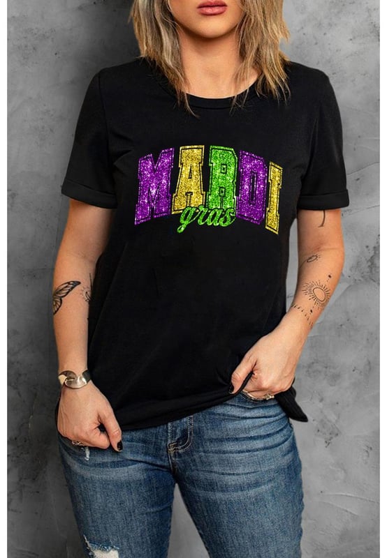 Our styles are designed with a trendy fitted look in mind following an international size standard. For the best fit we suggest choosing one size up from your usual. Be sure to check our sizing chart to find your perfect match!
  Black Mardi Gras Heat Transfer Graphic Holiday Tee
  Ideal for celebrating the carnival season
  Features iconic Mardi Gras elements
  Glittering heat
  transfer pattern adds a touch of sparkle
  Pairs well with jeans or shorts for a stylish outfit
  Easy to customize with various designs
Material: 62% Polyester 32% Cotton 6% Elastane