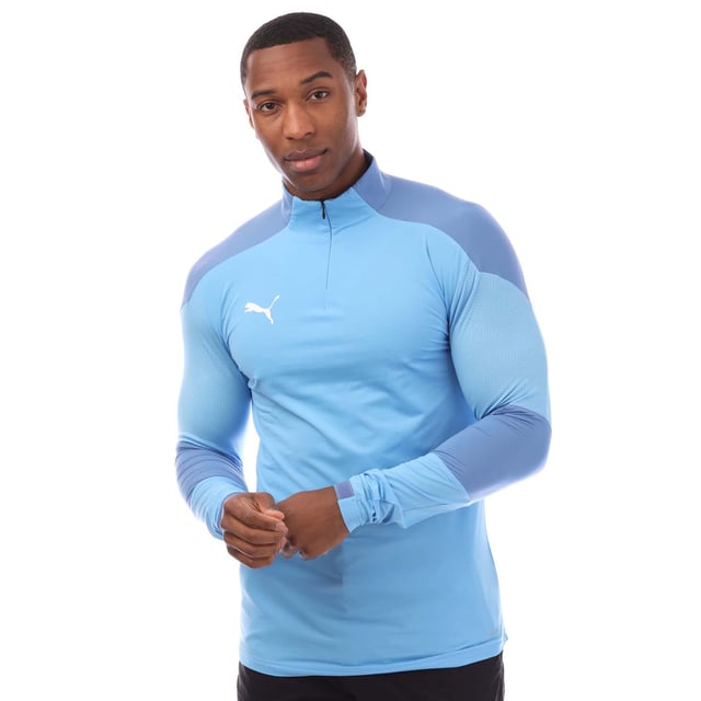 Mens Puma Final Training ¼ Zip Top in blue.- ¼ zip front.- Long sleeves.- Bold PUMA logo on the front.- Engineered fabric for breathability and graphical contrast on shoulders and arm.- Dropped back hem. - DRYCELL keeps you dry and cool.- Light  breathable material.- 87% Polyamide  13% Elastane.- Ref: 65647518M18