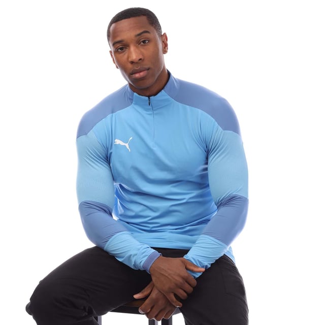 Mens Puma Final Training ¼ Zip Top in blue.- ¼ zip front.- Long sleeves.- Bold PUMA logo on the front.- Engineered fabric for breathability and graphical contrast on shoulders and arm.- Dropped back hem. - DRYCELL keeps you dry and cool.- Light  breathable material.- 87% Polyamide  13% Elastane.- Ref: 65647518M18