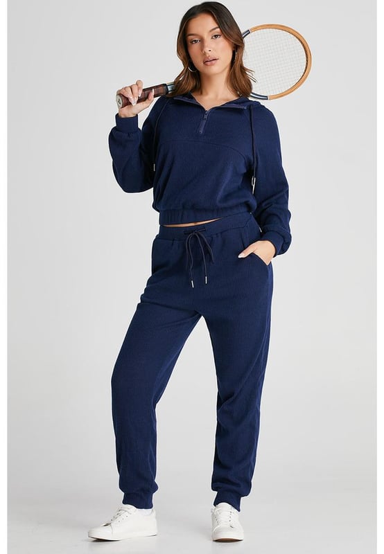Our styles are designed with a trendy fitted look in mind following an international size standard. For the best fit we suggest choosing one size up from your usual. Be sure to check our sizing chart to find your perfect match!
  Navy blue ribbed knit cropped hoodie and drawstring joggers set
  Coordinated outfit for a stylish look
  Trendy ribbed
  knit design for a textured appearance
  Adjustable drawstring on the waist for a customized fit
  Crafted from quality fabric for ultra comfort during workouts
  Suitable for both workouts and casual wear
Material: 95% Polyester 5% Elastane