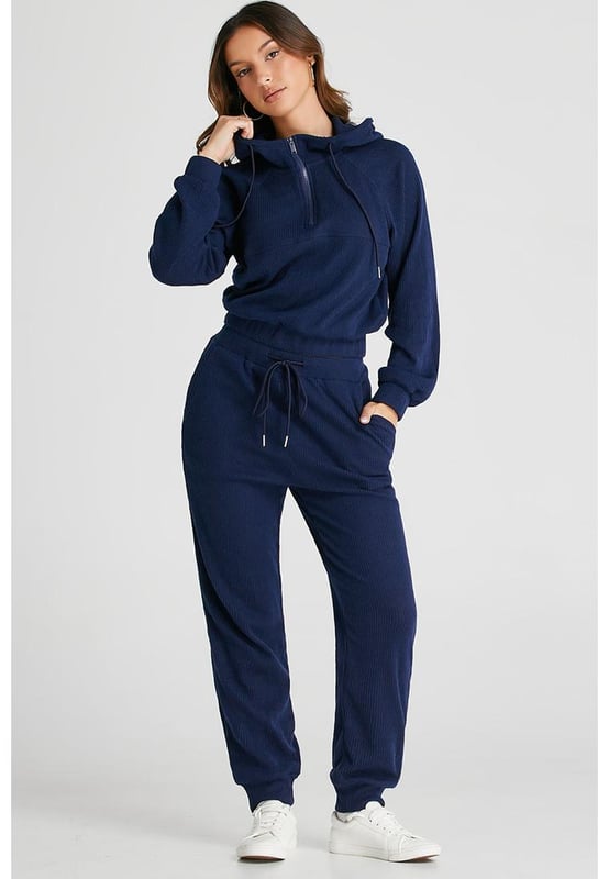 Our styles are designed with a trendy fitted look in mind following an international size standard. For the best fit we suggest choosing one size up from your usual. Be sure to check our sizing chart to find your perfect match!
  Navy blue ribbed knit cropped hoodie and drawstring joggers set
  Coordinated outfit for a stylish look
  Trendy ribbed
  knit design for a textured appearance
  Adjustable drawstring on the waist for a customized fit
  Crafted from quality fabric for ultra comfort during workouts
  Suitable for both workouts and casual wear
Material: 95% Polyester 5% Elastane