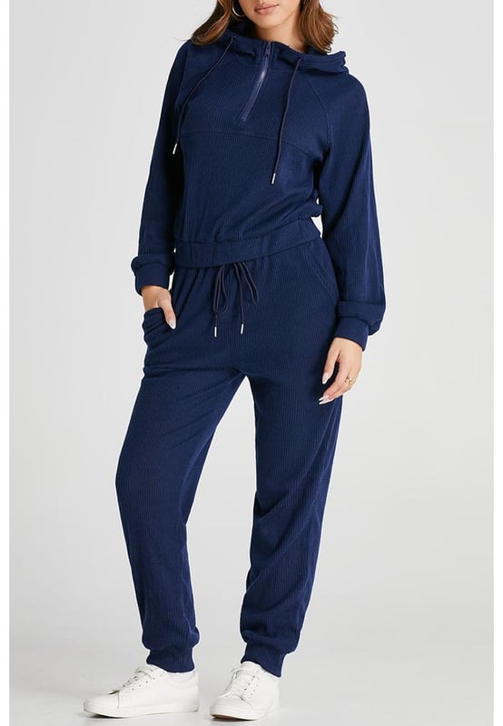 Our styles are designed with a trendy fitted look in mind following an international size standard. For the best fit we suggest choosing one size up from your usual. Be sure to check our sizing chart to find your perfect match!
  Navy blue ribbed knit cropped hoodie and drawstring joggers set
  Coordinated outfit for a stylish look
  Trendy ribbed
  knit design for a textured appearance
  Adjustable drawstring on the waist for a customized fit
  Crafted from quality fabric for ultra comfort during workouts
  Suitable for both workouts and casual wear
Material: 95% Polyester 5% Elastane