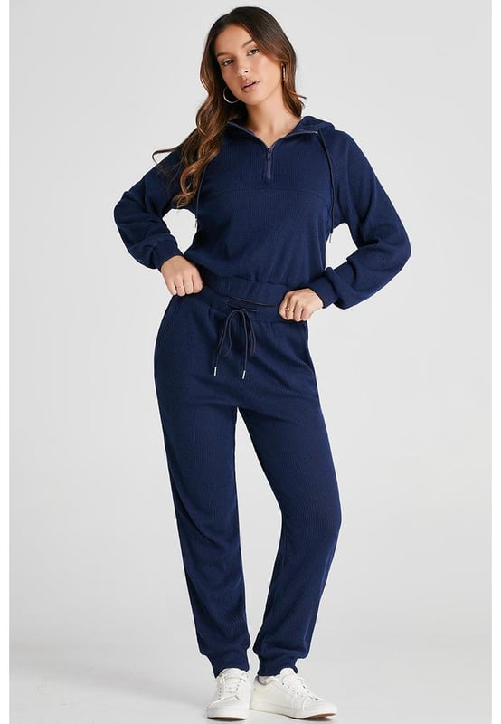 Our styles are designed with a trendy fitted look in mind following an international size standard. For the best fit we suggest choosing one size up from your usual. Be sure to check our sizing chart to find your perfect match!
  Navy blue ribbed knit cropped hoodie and drawstring joggers set
  Coordinated outfit for a stylish look
  Trendy ribbed
  knit design for a textured appearance
  Adjustable drawstring on the waist for a customized fit
  Crafted from quality fabric for ultra comfort during workouts
  Suitable for both workouts and casual wear
Material: 95% Polyester 5% Elastane