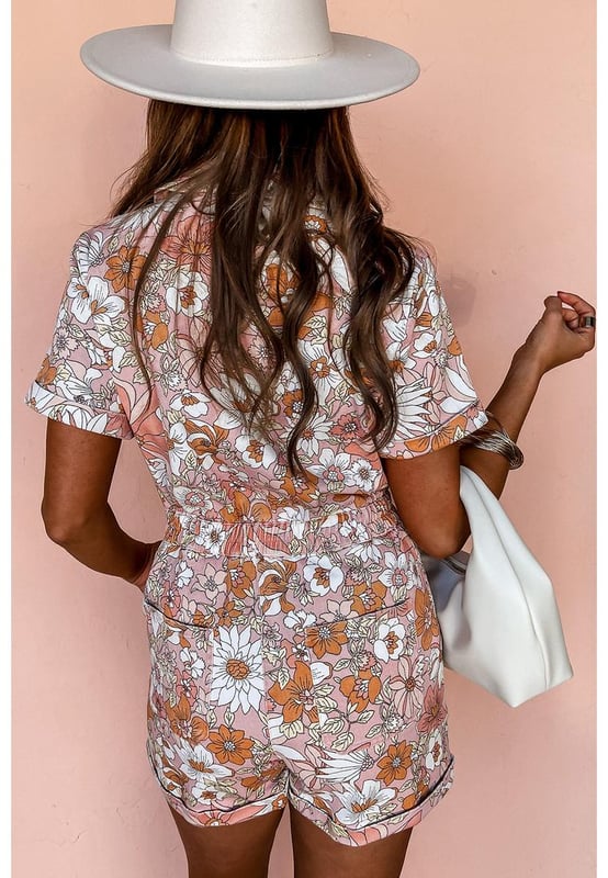 Our styles are designed with a trendy fitted look in mind following an international size standard. For the best fit we suggest choosing one size up from your usual. Be sure to check our sizing chart to find your perfect match!
  Pink floral short sleeve collared button front romper
  Perfect for summer days with a playful flower print
  Short cuffed sleeves and cuffed hem
  Collared neck and buttoned bodice
  Features chest pockets and pocketed shorts
  Elastic back waistline for a comfortable fit
Material: 100% Polyester