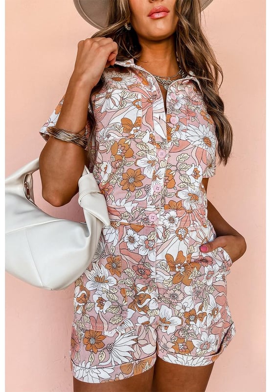 Our styles are designed with a trendy fitted look in mind following an international size standard. For the best fit we suggest choosing one size up from your usual. Be sure to check our sizing chart to find your perfect match!
  Pink floral short sleeve collared button front romper
  Perfect for summer days with a playful flower print
  Short cuffed sleeves and cuffed hem
  Collared neck and buttoned bodice
  Features chest pockets and pocketed shorts
  Elastic back waistline for a comfortable fit
Material: 100% Polyester