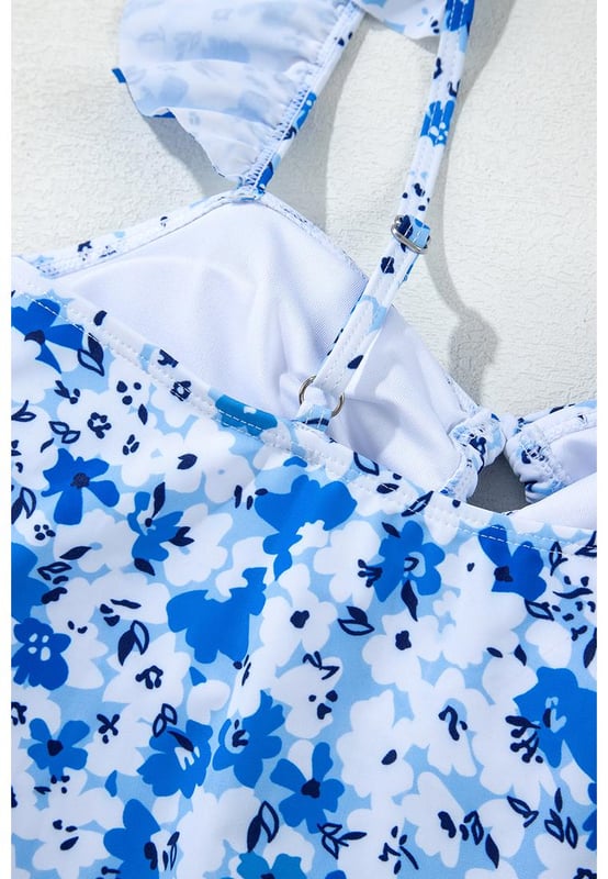 Our styles are designed with a trendy fitted look in mind following an international size standard. For the best fit we suggest choosing one size up from your usual. Be sure to check our sizing chart to find your perfect match!
  Vibrant blue floral print
  Ruffled straps
  Hollow
  out front design
  Lace
  up detail
  Available in sizes S to XL
  High elasticity for a comfortable fit
Material: 85% Polyester 15% Elastane