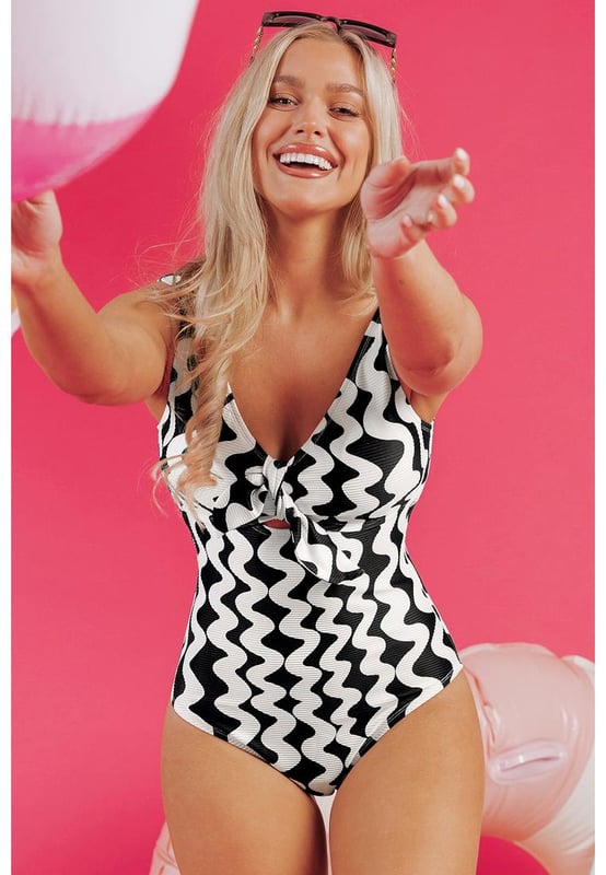 Our styles are designed with a trendy fitted look in mind following an international size standard. For the best fit we suggest choosing one size up from your usual. Be sure to check our sizing chart to find your perfect match!
  Stylish bowknot detail adds a flirty touch
  Eye
  catching ricrac print for a playful look
  Flattering V
  neck and low back cut design
  Comfortable one
  piece swimsuit for beach fun
Material: 95% Polyester 5% Elastane