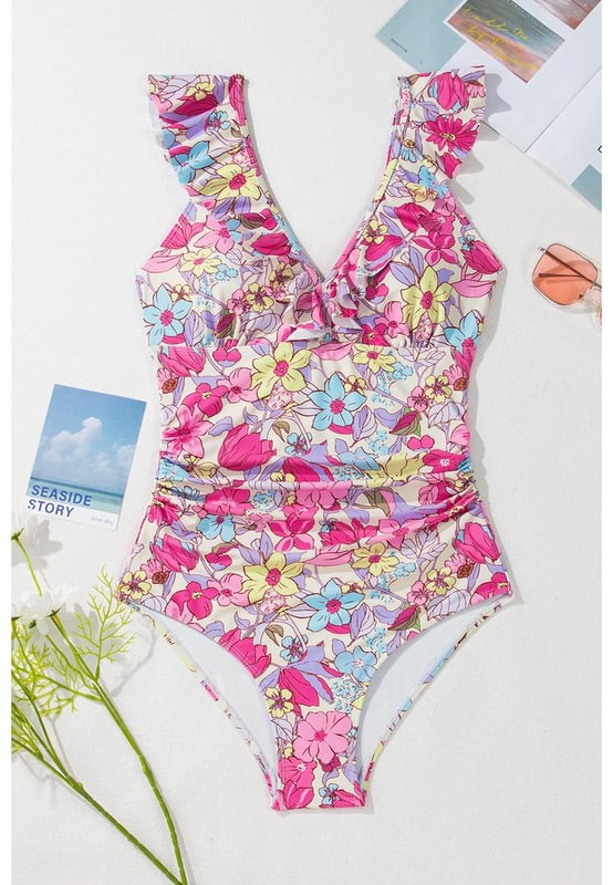 Our styles are designed with a trendy fitted look in mind following an international size standard. For the best fit we suggest choosing one size up from your usual. Be sure to check our sizing chart to find your perfect match!
  One
  piece swimsuit
  Pink floral design
  V neckline with ruffle details
  Lace
  up tie at the back
  Tummy control feature
  High stretch material
  Classic bum coverage