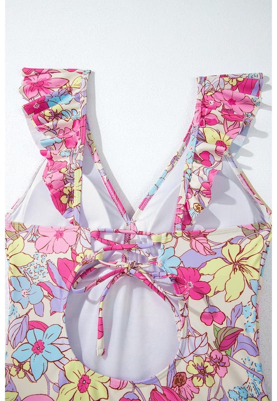 Our styles are designed with a trendy fitted look in mind following an international size standard. For the best fit we suggest choosing one size up from your usual. Be sure to check our sizing chart to find your perfect match!
  One
  piece swimsuit
  Pink floral design
  V neckline with ruffle details
  Lace
  up tie at the back
  Tummy control feature
  High stretch material
  Classic bum coverage
