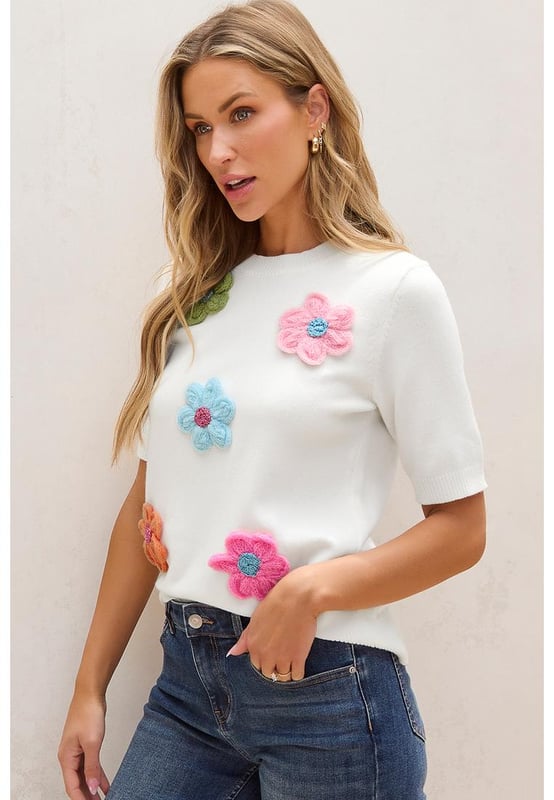 Our styles are designed with a trendy fitted look in mind following an international size standard. For the best fit we suggest choosing one size up from your usual. Be sure to check our sizing chart to find your perfect match!
  Adorable flower applique adds a charming touch
  Short sleeves style for a versatile and stylish look
  Breathable soft and cozy knitwear
  Perfect for layering or wearing on its own
  Available in various sizes to suit your style
  High elasticity for a comfortable fit
Material: 50% Viscose 28% Polyester 22% Polyamide