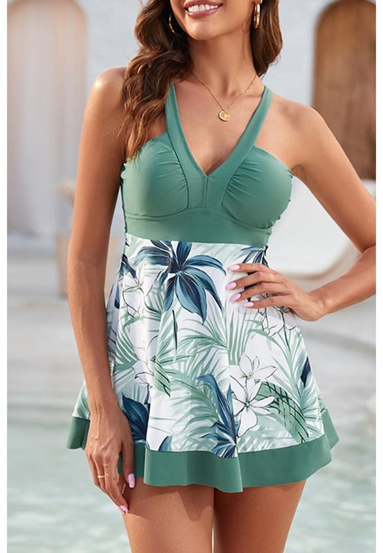 Our styles are designed with a trendy fitted look in mind following an international size standard. For the best fit we suggest choosing one size up from your usual. Be sure to check our sizing chart to find your perfect match!
  Green floral patchwork V neck swimdress with shorts
  V neck design flatters collarbones
  Charming floral pattern
  Included shorts provide extra coverage and easy movement
  Fit and flare style is feminine and flattering
Material: 82% Polyester 18% Spandex