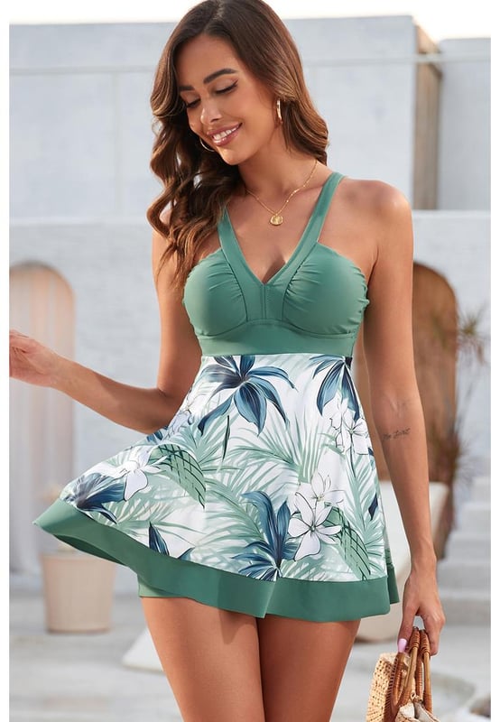 Our styles are designed with a trendy fitted look in mind following an international size standard. For the best fit we suggest choosing one size up from your usual. Be sure to check our sizing chart to find your perfect match!
  Green floral patchwork V neck swimdress with shorts
  V neck design flatters collarbones
  Charming floral pattern
  Included shorts provide extra coverage and easy movement
  Fit and flare style is feminine and flattering
Material: 82% Polyester 18% Spandex