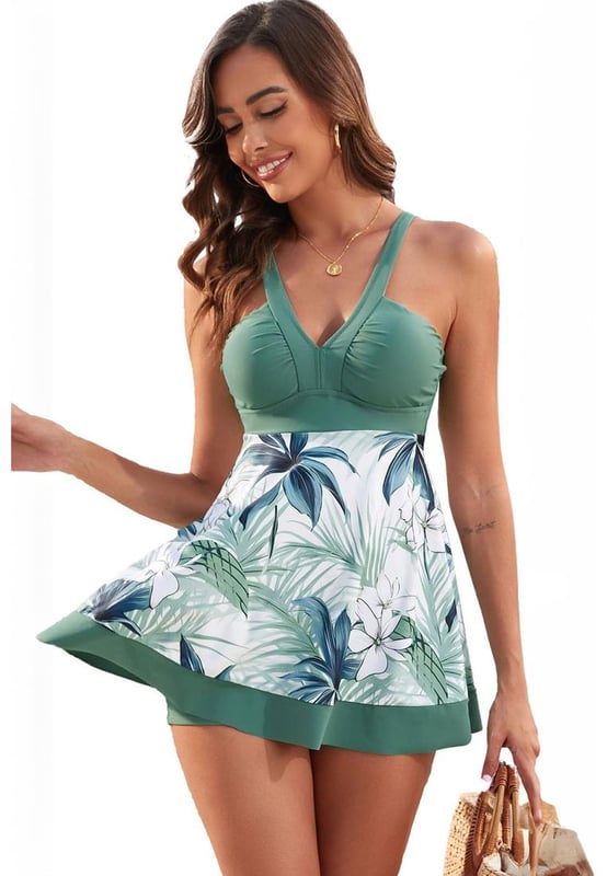 Our styles are designed with a trendy fitted look in mind following an international size standard. For the best fit we suggest choosing one size up from your usual. Be sure to check our sizing chart to find your perfect match!
  Green floral patchwork V neck swimdress with shorts
  V neck design flatters collarbones
  Charming floral pattern
  Included shorts provide extra coverage and easy movement
  Fit and flare style is feminine and flattering
Material: 82% Polyester 18% Spandex