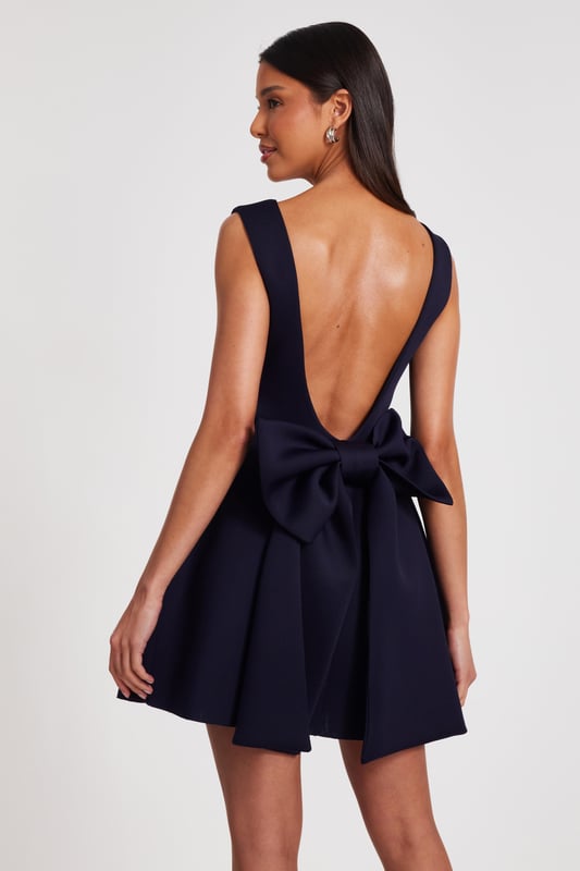- Bow detail - Square neck - Low back - Skater style - Model height: 5'9" - Model wears uk 8 / us 4 / eur 36 - Always check the wash care label - Cool hand wash with mild detergent