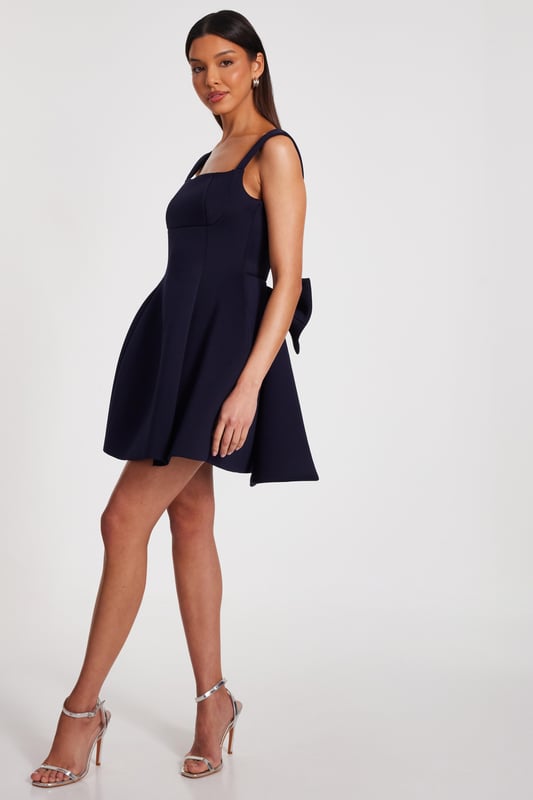 - Bow detail - Square neck - Low back - Skater style - Model height: 5'9" - Model wears uk 8 / us 4 / eur 36 - Always check the wash care label - Cool hand wash with mild detergent