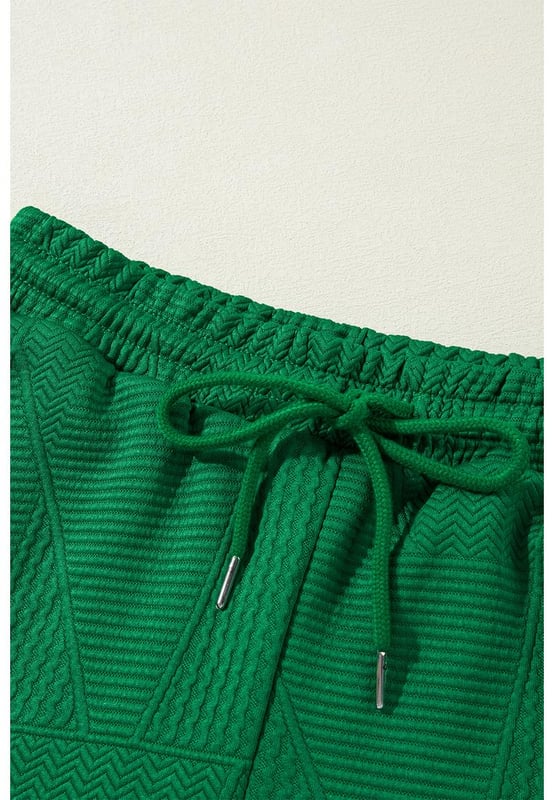 Our styles are designed with a trendy fitted look in mind following an international size standard. For the best fit we suggest choosing one size up from your usual. Be sure to check our sizing chart to find your perfect match!
  Dark green two
  piece set
  Includes ruffled sleeve summer top and cropped loose pants
  Crew neck top with feminine ruffled sleeves
  Cropped pants with adjustable drawstring waistline
  Made from textured fabric
  Ideal for summer outings
Material: 97% Polyester 3% Elastane