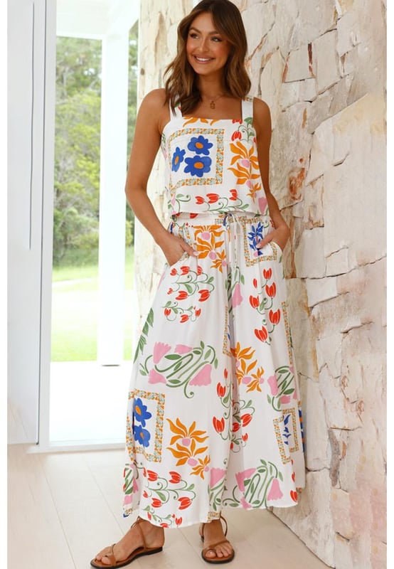 Our styles are designed with a trendy fitted look in mind following an international size standard. For the best fit we suggest choosing one size up from your usual. Be sure to check our sizing chart to find your perfect match!
  White Colorful Printed Square Neck Tank and Wide Leg Pants Set
  Square
  neck tank with wide straps
  Wide
  leg pants for a flowy silhouette
  Feminine floral design
  Soft comfortable fabric for all
  day wear
Material: 100% Viscose