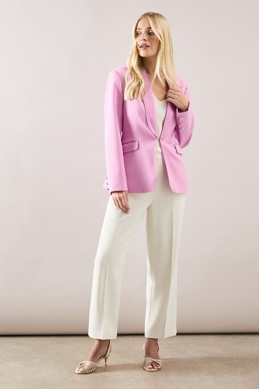 Elegant shawl collar design creates a sophisticated silhouette
        Edge to edge front opening offers versatile styling options
        Functional side pockets provide practicality without compromising style
        Regular fit ensures comfortable wear throughout the day
        Subtle button detailing on cuffs adds refined finishing touches
    
    This Petite Shawl Collar Edge To Edge Jacket from Wallis is the perfect addition to your daywear collection. The sophisticated shawl collar frames the face beautifully, whilst the clean edge to edge design creates a streamlined look that works wonderfully with both casual and smart outfits. Style as seen with wide-leg trousers and a simple top for an effortlessly chic ensemble, or pair with your favourite jeans and a blouse for weekend brunches. The regular fit is designed to flatter the petite frame, with proportions carefully considered to enhance your silhouette. This versatile piece transitions seamlessly from family gatherings to lunch dates, and can be dressed up with statement jewellery or kept minimal for a more understated look. Complete your outfit with ballet flats or low block heels for comfortable yet stylish daytime wear.