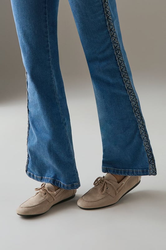 Faux suede boat shoes with classic moccasin-inspired design
        Traditional lace detail with neat bow fastening for adjustable fit
        Comfortable flat heel measuring between 0-2cm for all-day wear
        Soft rounded toe shape offering ample room for movement
        Subtle stitching detail around the upper for added visual interest
    
    The Faith Nico boat shoes blend timeless nautical charm with everyday practicality. These versatile flats feature the classic boat shoe silhouette reimagined in soft faux suede for a contemporary twist on a wardrobe staple. Perfect for casual weekend outings, pair them with wide-leg jeans as shown for an effortlessly chic look, or style with cropped trousers and a crisp white shirt for smart-casual occasions. The neutral tone makes these shoes incredibly adaptable for your wardrobe, while the comfortable flat design ensures they're suitable for long days of wear. Ideal for family gatherings, shopping trips or casual lunches, these boat shoes offer the perfect balance of comfort and style without compromising on either. Their understated design makes them a reliable choice for transitional weather, working beautifully with both summer dresses and autumn layering pieces.
