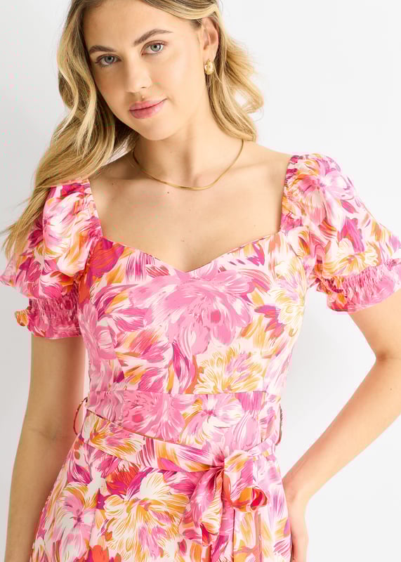This dress is perfect for any occasion with its red floral design, puff sleeves, and belted waist. The comfortable fit and midi length make it a must-have in your wardrobe. Add a touch of casual elegance to your style with this dress.
