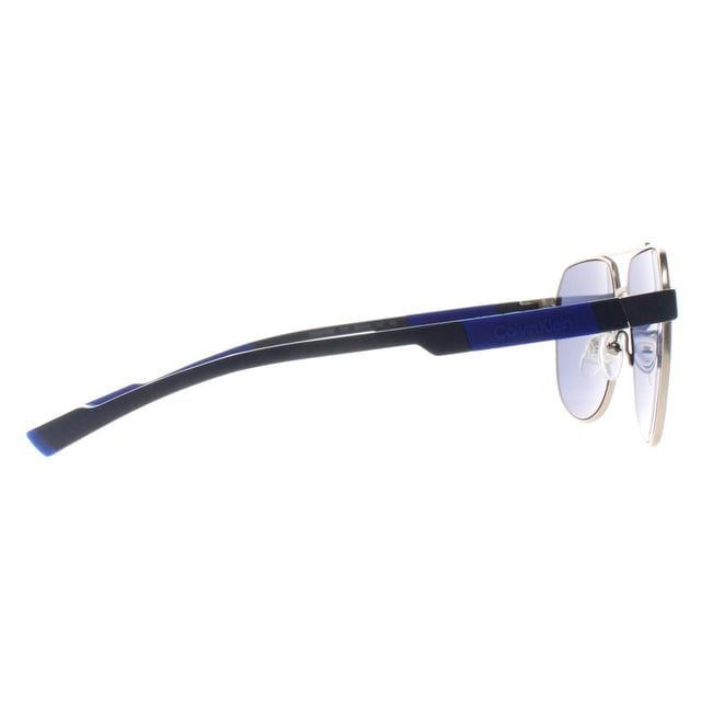 Calvin Klein Aviator Mens Gold Blue CK23103S  Sunglasses is a sharp and angular frame that makes a bold fashion statement. Designed with Calvin Klein's signature aesthetic, it combines clean lines and contemporary styling to create a unique and versatile piece. The frame is lightweight yet sturdy, and its refined construction ensures a secure and comfortable fit, perfect for individuals who prefer an edgier, more fashion-forward look.