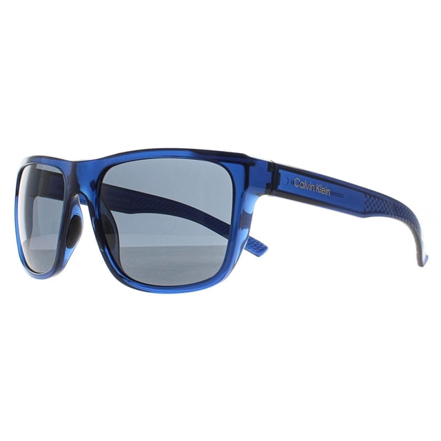 Calvin Klein Rectangle Mens Deep Transparent Blue Grey CK22556S  Sunglasses is designed for those who want their eyewear to make a statement. The frameâ€™s unique shape and high quality materials ensure both style and comfort. With a modern twist on classic eyewear, this pair is perfect for individuals looking to add a touch of elegance to their wardrobe while enjoying a durable and functional design.