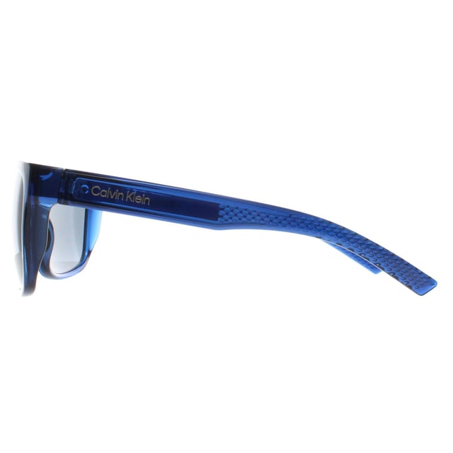 Calvin Klein Rectangle Mens Deep Transparent Blue Grey CK22556S  Sunglasses is designed for those who want their eyewear to make a statement. The frameâ€™s unique shape and high quality materials ensure both style and comfort. With a modern twist on classic eyewear, this pair is perfect for individuals looking to add a touch of elegance to their wardrobe while enjoying a durable and functional design.