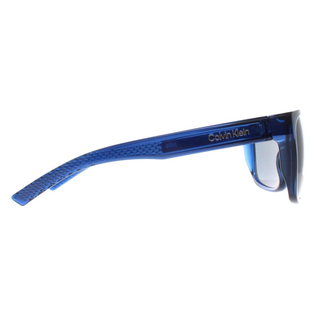 Calvin Klein Rectangle Mens Deep Transparent Blue Grey CK22556S  Sunglasses is designed for those who want their eyewear to make a statement. The frameâ€™s unique shape and high quality materials ensure both style and comfort. With a modern twist on classic eyewear, this pair is perfect for individuals looking to add a touch of elegance to their wardrobe while enjoying a durable and functional design.