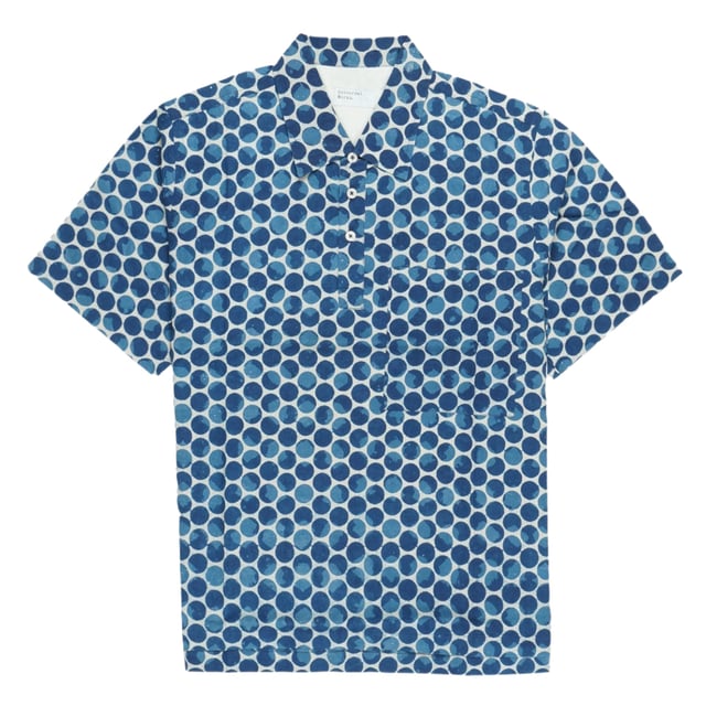 This British designer is a brand shaped by a deep appreciation of the musical and sporting subcultures that underpin the everyday life of British men. Universal Works takes its cultural and contextual heritage and layers it under a nuanced understanding of contemporary menswear needs. Adding contemporary print to your looks, this short-sleeved polo shirt features a contemporary spotty print, with a collared neckline, and a breast pocket. Style this polo shirt with a Universal Works jacket, and your favourite Paul Smith trainers.

Size &amp; Fit:

True to size
Regular fit
Details:

100% Cotton
30C wash
Low heat iron
Made in India