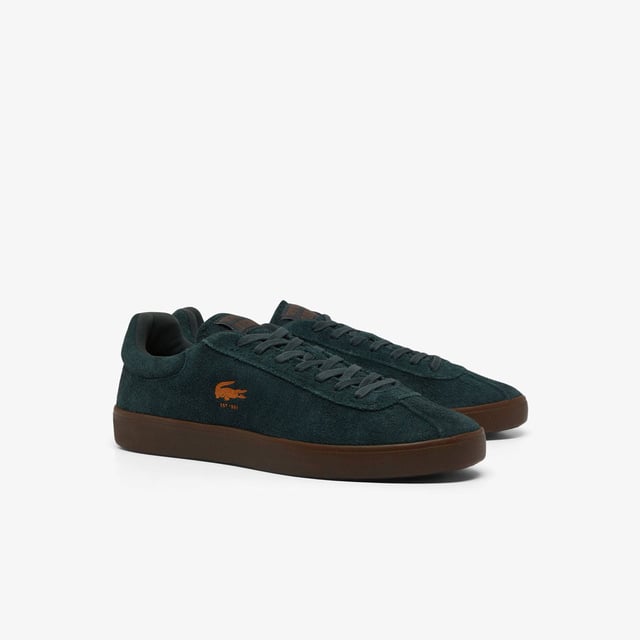 Men's Lacoste Baseshot Suede Trainers in Green Men's Baseshot Suede Sneakers Premium suede upper Padded collar for increased comfort and support Vintage tennis label on tongue Supple high-grip rubber outsole Debossed retro crocodile on front panel