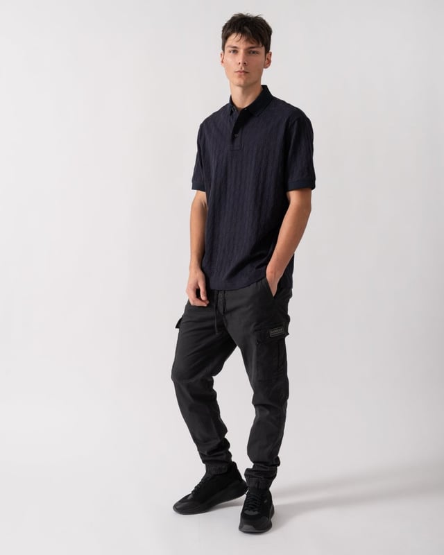 This short-sleeved cotton polo combines style and comfort, perfect for any casual occasion. Crafted from soft cotton, it ensures a fresh and breathable fit. The design is enriched by an allover tone-on-tone logo, which gives an elegant and discreet touch. With a ribbed collar and contrasting buttons, this polo is versatile and easy to match with jeans, trousers or shorts. An essential piece for those seeking a sophisticated but informal look.




Regular fit polo
In cotton
Allover tone-on-tone logo
Short sleeves



Fabric: 100% cotton; rib details: 98% polyester, 2% elastane